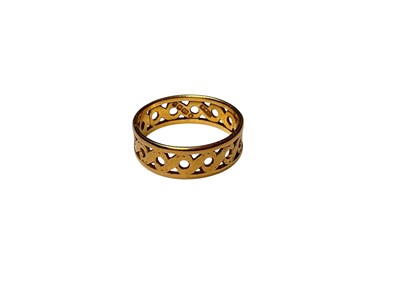 Lot 133 - 22ct gold wedding band with pierced decoration (London 1954), size N