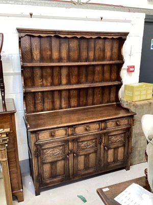 Lot 5361 - 17th century style carved solid oak two height dresser with plate rack above three drawers and cupboards below enclosed by carved panel doors, 138cm wide x 184cm tall x 46cm deep