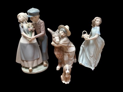 Lot 2262 - Four Lladro porcelain figures including Dutch Couple with Tulips, model no.5124 and Platero & Marcelino (three are boxed)