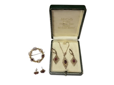 Lot 106 - 9ct gold garnet pendant necklace, two pairs of similar earrings and a 9ct gold garnet and pearl wreath brooch