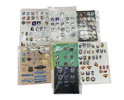 Lot 740 - Collection of seven boards, each mounted with various American military badges, (1 box).