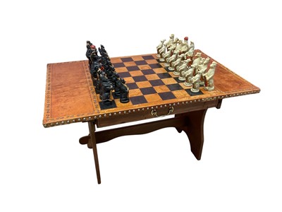Lot 3013 - Leather clad chess table, with resin animal form chess pieces