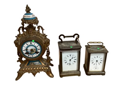 Lot 5067 - Two brass cased carriage clocks, a French brass cased and porcelain clock and a 19th century mahogany cased banjo barometer (4)