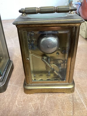 Lot 5067 - Two brass cased carriage clocks, a French brass cased and porcelain clock and a 19th century mahogany cased banjo barometer (4)