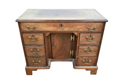 Lot 1364 - George III mahogany kneehole desk with an arrangement of seven drawers about a central cupboard kneehole