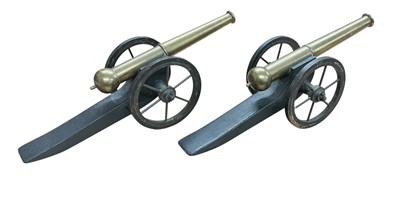 Lot 70 - Pair of early 20th century decorative brass cannons on wooden gun carriages, each 32cm in overall length.