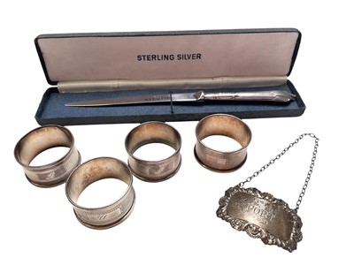 Lot 153 - Four silver napkins rings, silver decanter label engraved 'Port' and a contemporary silver handled letter opener in box