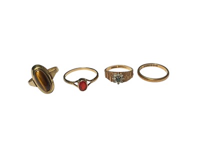 Lot 160 - Yellow metal tiger's eye ring (stamped 585), two 9ct gold gem set dress rings and 9ct gold wedding ring (4)