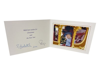 Lot 41 - H.M. Queen Elizabeth II and H.R.H. The Duke of Edinburgh, signed 2002 Christmas card with twin gilt cyphers to cover, colour photograph of the smiling Royal couple riding in the State Coach to the...