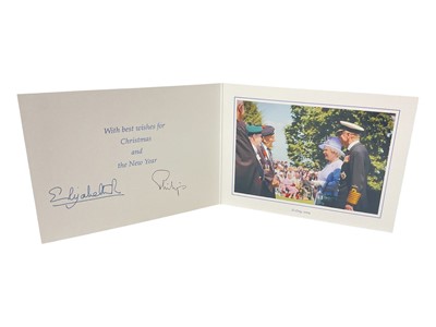 Lot 42 - H.M. Queen Elizabeth II and H.R.H. The Duke of Edinburgh, signed 2004 Christmas card with twin gilt cyphers to cover, colour photograph of the smiling Royal couple meeting D-Day veterans to the in...