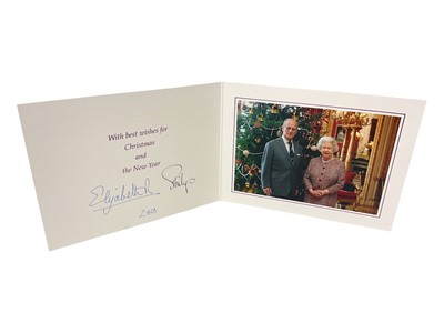 Lot 43 - H.M. Queen Elizabeth II and H.R.H. The Duke of Edinburgh signed 2010 Christmas card with twin gilt cyphers to cover, colour photograph of the smiling Royal couple next to a Christmas tree to the...