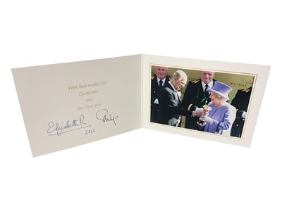 Lot 45 - H.M. Queen Elizabeth II and H.R.H. The Duke of Edinburgh, signed 2012 Christmas card with twin gilt cyphers to cover, colour photograph of the smiling Queen being presented with the Gold Cup by th...