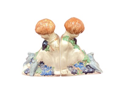 Lot 5029 - Percy Metcalfe for Ashtead Pottery, a pair bookends in the form of a boy with pigeons, printed marks to base