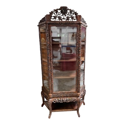 Lot 1437 - Late 19th / early 20th century Chinese hardwood display cabinet, the glazed door flanked by glazed angled side panels, richly carved with fruiting vines
