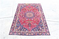 Lot 1443 - Meshed rug - claret-red field centred by...