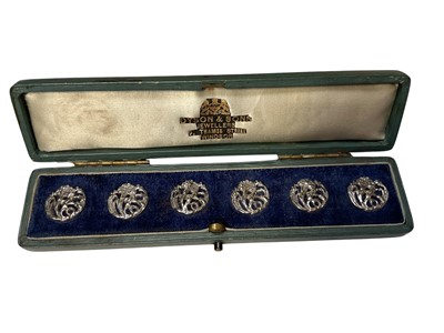 Lot 200 - Set of six Art Nouveau silver buttons with pierced floral decoration in fitted case