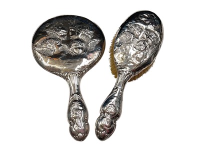 Lot 204 - Silver backed dressing table mirror and brush, both with Reynolds Angels decoration (2)