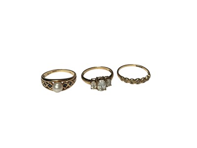Lot 234 - Three 9ct gold dress rings to include a cultured pearl and sapphire ring, three stone ring and a chain-link style ring