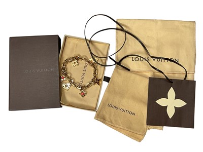 Lot 283 - Louis Vuitton gilt metal monogram charm bracelet, in original box with pouches and cleaning cloth