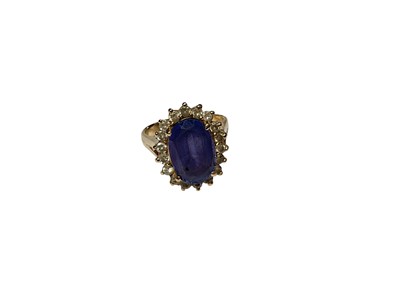 Lot 281 - Tanzanite and diamond cocktail ring with a central oval mixed cut tanzanite surrounded by a border of brilliant cut diamonds in a yellow gold setting, marked 14K. Ring size N½