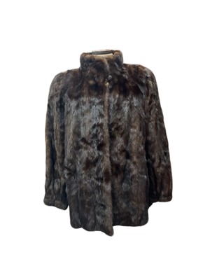 Lot 2565 - Dark brown mink fur jacket with stand-up collar and shoulder pads.