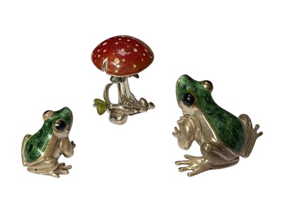 Lot 242 - Two contemporary silver and enamel frogs and a toadstool ornaments (3)