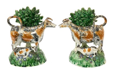 Lot 200 - Rare pair of pearlware pottery cow creamers, collection labels to underside
