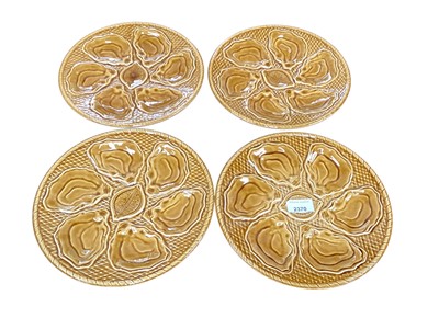 Lot 2370 - Set of four French treacle glazed oyster plates, each 25cm in diameter, (4)