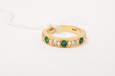 Lot 250 - Diamond and emerald seven stone half eternity ring