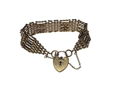 Lot 255 - 9ct gold gate bracelet with engraved padlock clasp