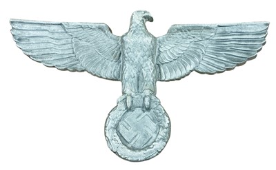 Lot 831 - Large metal Nazi German eagle and swastika plaque, with drilled and screw fitting holes to reverse, 67cm in overall diameter.