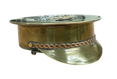 Lot 859 - First World War brass Trench Art snuff box in the form of an officers cap, mounted with a Hampshire Regiment cap badge and dated 1916.