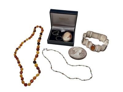Lot 292 - Continental silver (800) panel bracelet mounted with an amber cabochon, amber bead necklace, two carved shell cameo brooches, paste set heart brooch etc