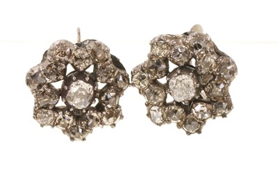 Lot 673 - Pair of antique diamond flower head cluster earrings