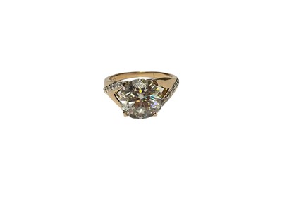 Lot 305 - Yellow metal white synthetic single stone ring in four claw setting with diamond set shoulders, marked 585