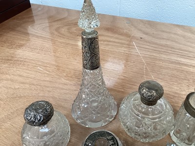 Lot 5038 - Group of silver topped scent/perfume bottles and other silver topped items