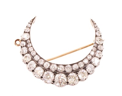 Lot 550 - A fine Victorian diamond crescent pendant/brooch with a double row of graduated old cut diamonds in silver collet setting, pierced gold gallery with hinged pendant fitting and detachable brooch...
