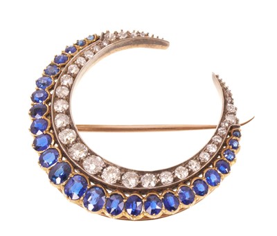 Lot 551 - A fine Victorian diamond and sapphire crescent brooch with graduated old cut diamonds and graduated oval mixed cut blue sapphires in silver and gold setting with pierced gold gallery and detacha...