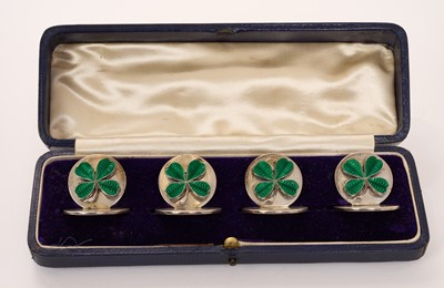 Lot 441 - Set of four early George V silver and enamel menu holders mounted with green enamelled shamrocks