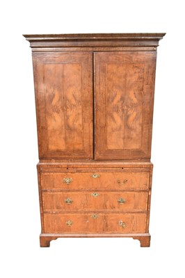Lot 1426 - Mid 18th century walnut crossbanded linen press, with cavetto moulded cornice and enclosed above by pair of door, the base with brushing slide and three long graduated drawers on bracket feet, 1...