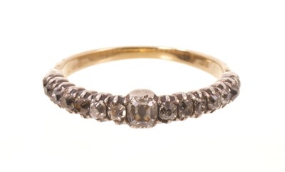 Lot 564 - Georgian diamond half hoop ring with a central old mine cut cushion shape diamond flanked by further graduated old mine cut diamonds, all in silver collet closed-back gold setting with floral de...