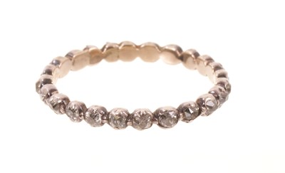 Lot 565 - Georgian diamond eternity ring with a full band of old cut diamonds in silver collet and gold closed-back setting, ring size approximately O.