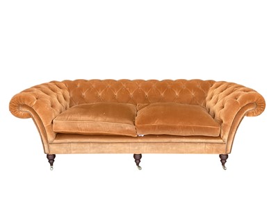 Lot 1470 - Fine quality chesterfield sofa by Fleming and Howland, copper coloured velvet button upholstery on turned legs and brass cappings and castors