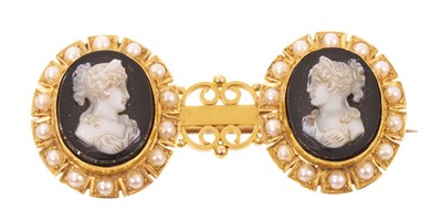 Lot 575 - Victorian carved sardonyx cameo brooch with a double cameo depicting classical female busts, each surrounded by a border of half pearls, in yellow metal mount, the back with inscription 'E.H. fr...