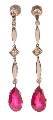Lot 579 - Pair of Art Deco diamond and synthetic ruby pendant earrings, each with a pear-cut red stone (not tested) suspended from an articulated drop set with diamonds in white gold setting, in a fitted...
