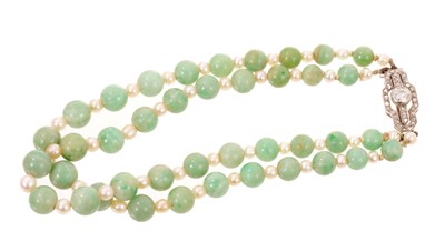 Lot 594 - Art Deco jade bead and cultured pearl bracelet, the double strand of graduated green jade beads 5.2-6.7mm, interspaced by 3-3.5mm cultured pearls, on an Art Deco diamond clasp, 21cm
