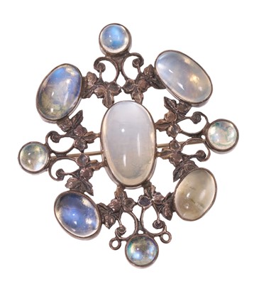 Lot 596 - Arts & Crafts silver and moonstone brooch with nine moonstone cabochons in silver setting with ivy leaf design, 55mm.