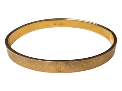 Lot 31 - 9ct gold bangle with engine turned decoration