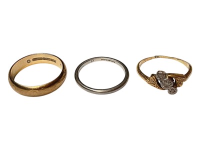 Lot 32 - 9ct gold wedding ring, platinum wedding ring and 18ct gold diamond three stone cross-over ring (3)