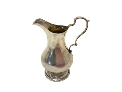 Lot 464 - George III silver cream jug of baluster form, with scroll handle, raised on a circular foot, (London 1791) maker's mark rubbed, all at 3.70ozs, 12cm in overall height.